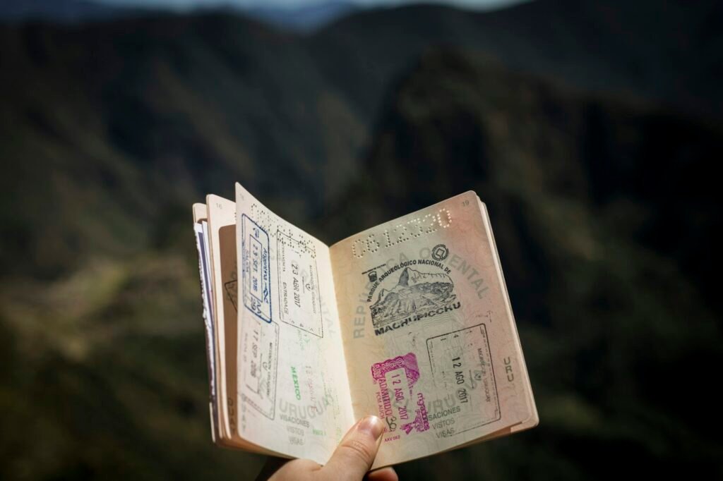 Traveller holding a passport in front of a light background