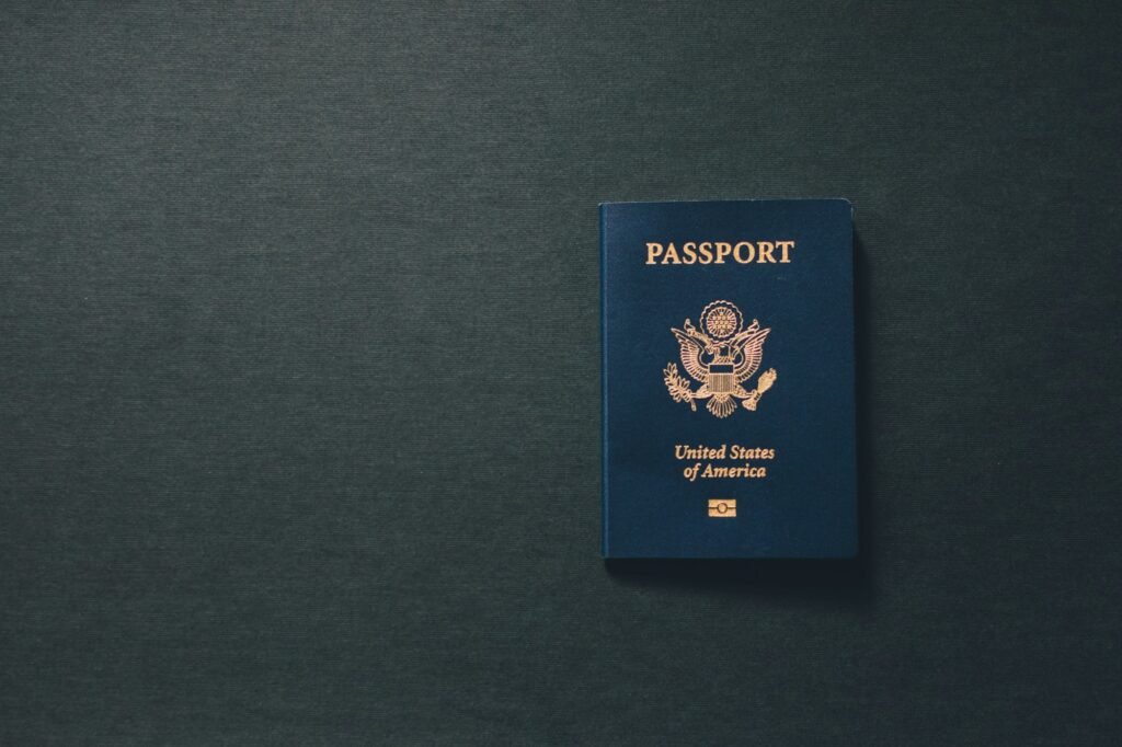 A passport booklet lying closed on a plain surface