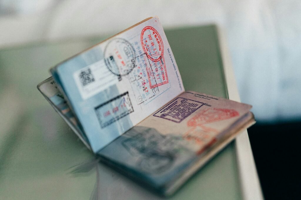 Open passport pages covered in immigration entry stamps